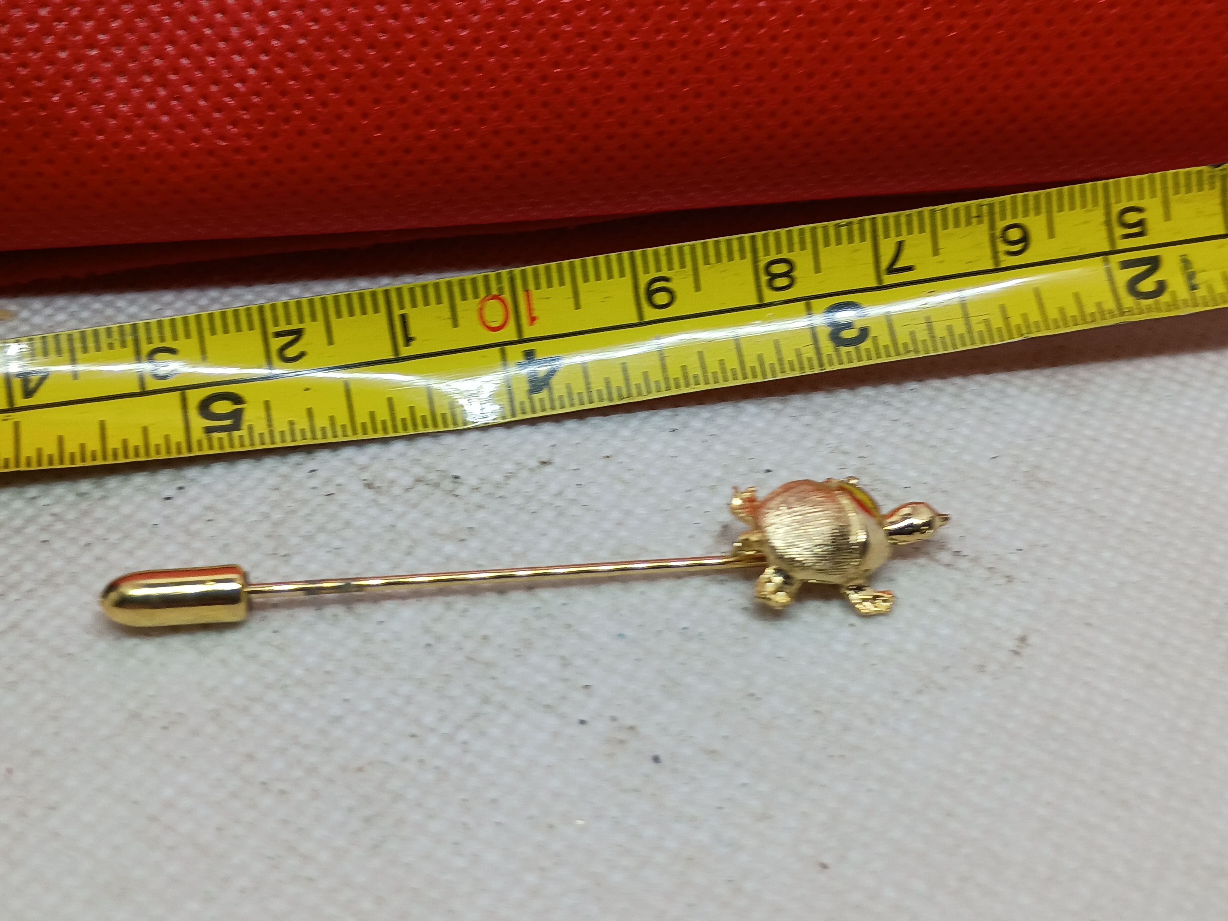2.5" Vintage gold-tone turtle stick pin featuring a textured shell