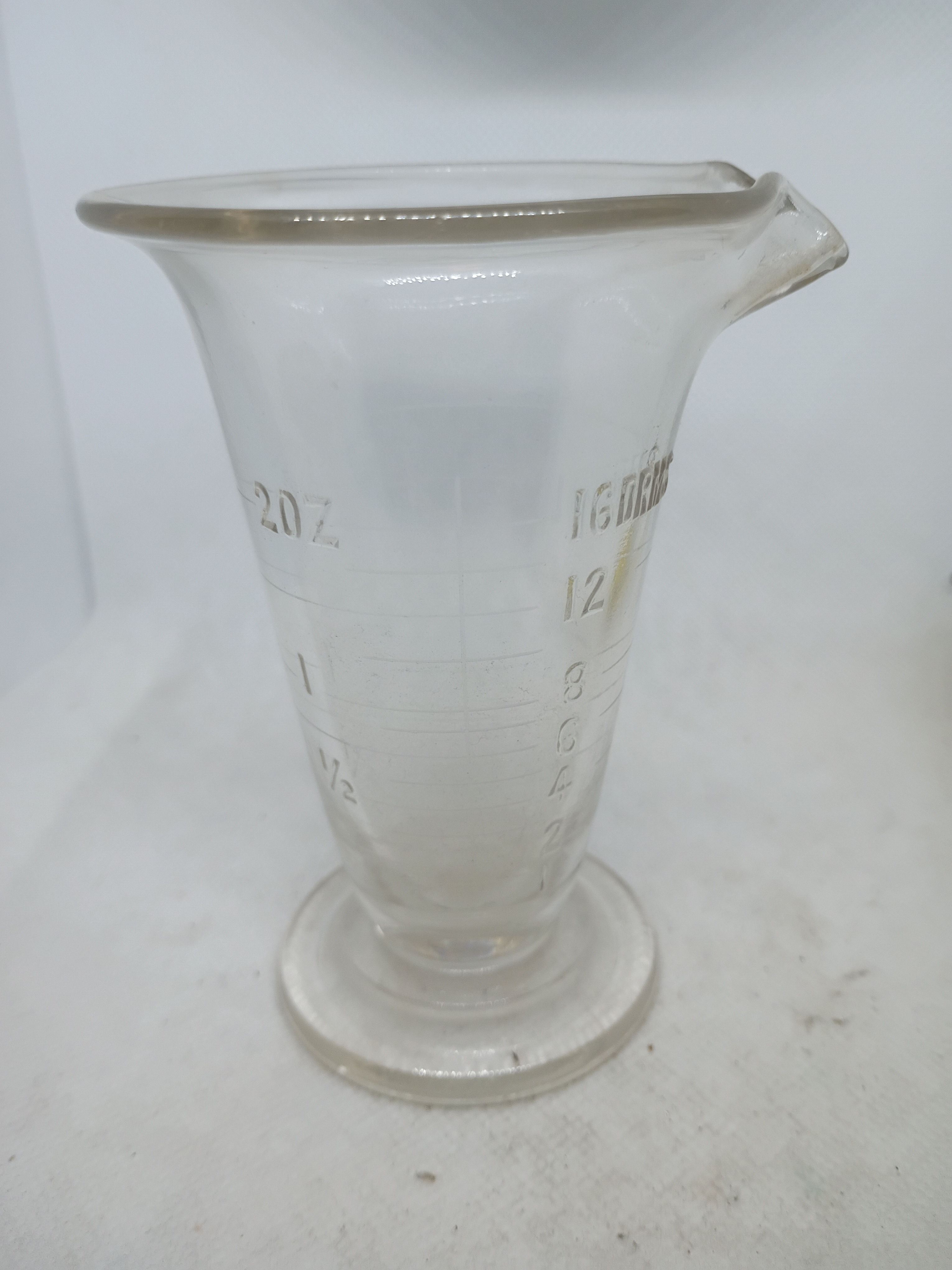 5" tall glass measuring beaker with pour spout in glass