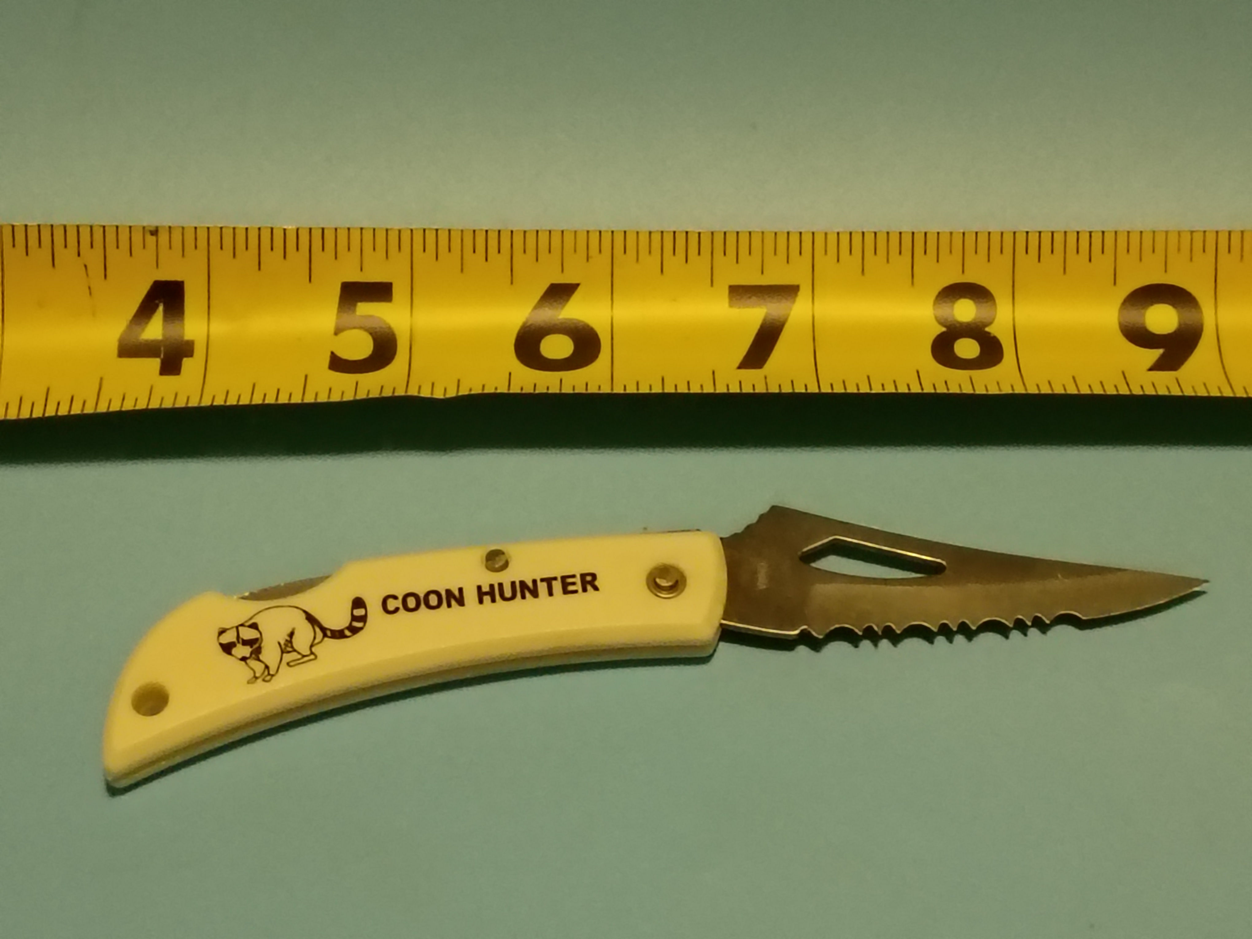 Approx 5" open -Folding knife- stainless steel blade- plastic handle Coon Hunter