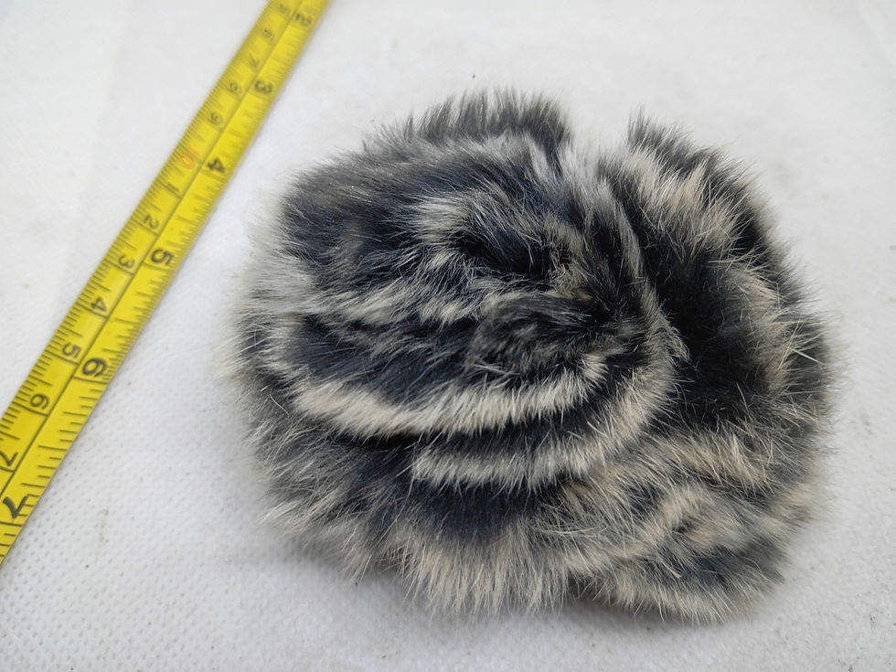 Thumbnail: 4" A decorative flower brooch or hair accessory made of black and white fur