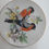 Thumbnail: 4" Porcelain plate adorned with 2 birds on a branch with  yellow flowers - Japan