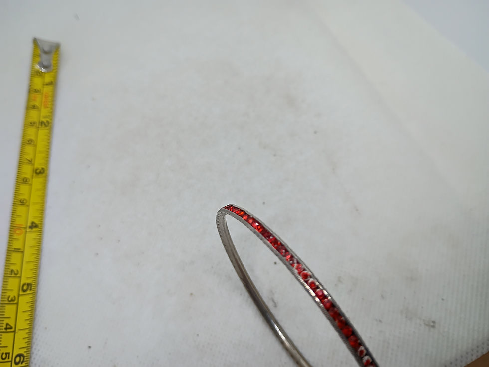 Thumbnail: Approx 2.5"  sterling silver bangle with a row of round-cut garnet gemstones