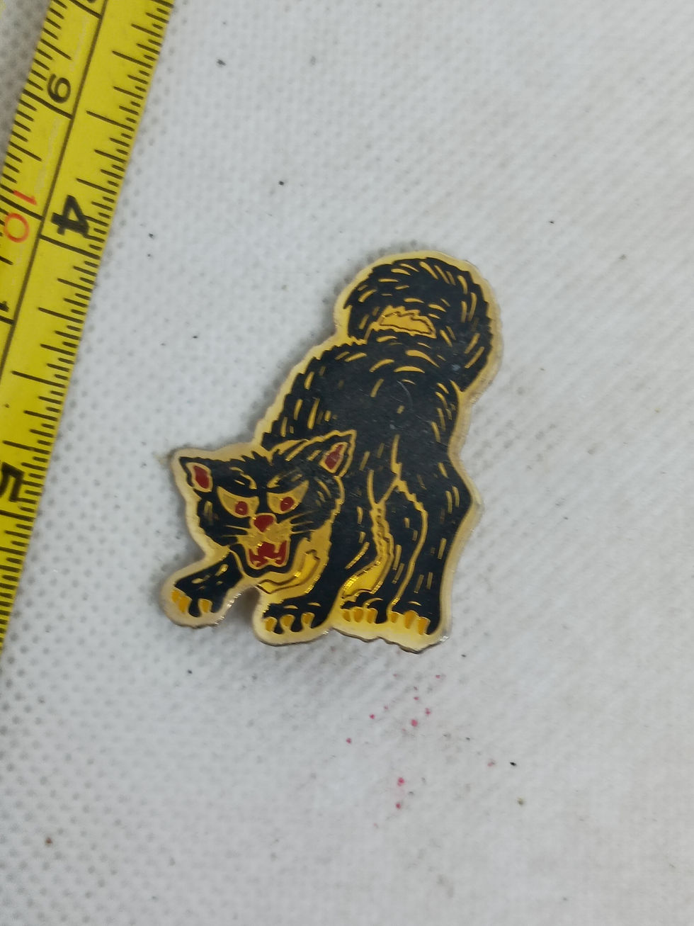Thumbnail: 1.5" This black and gold enamel pin features a cat in a striking, artistic style