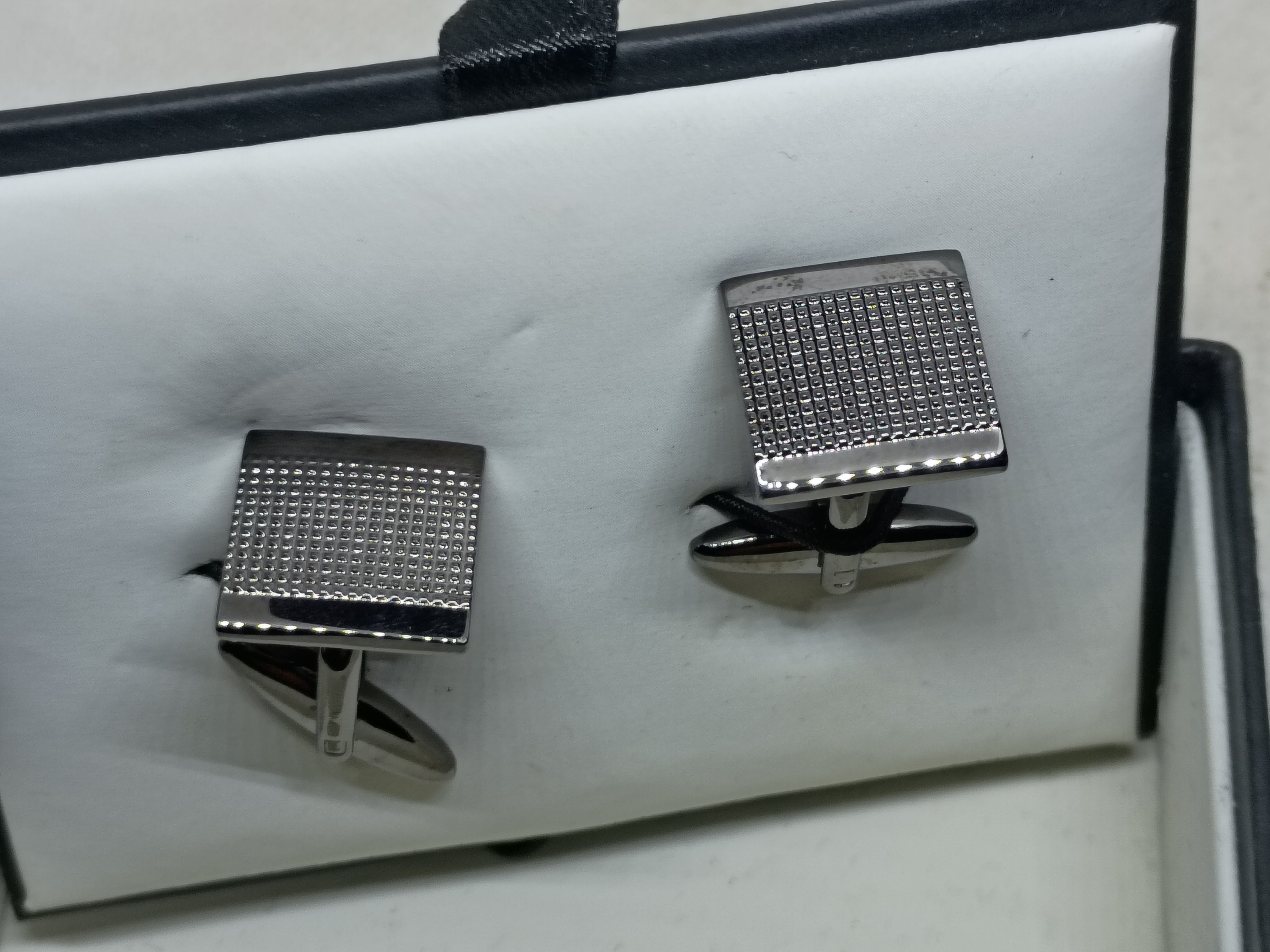 Van Heusen cufflinks feature a gunmetal-tone finish with a textured face
