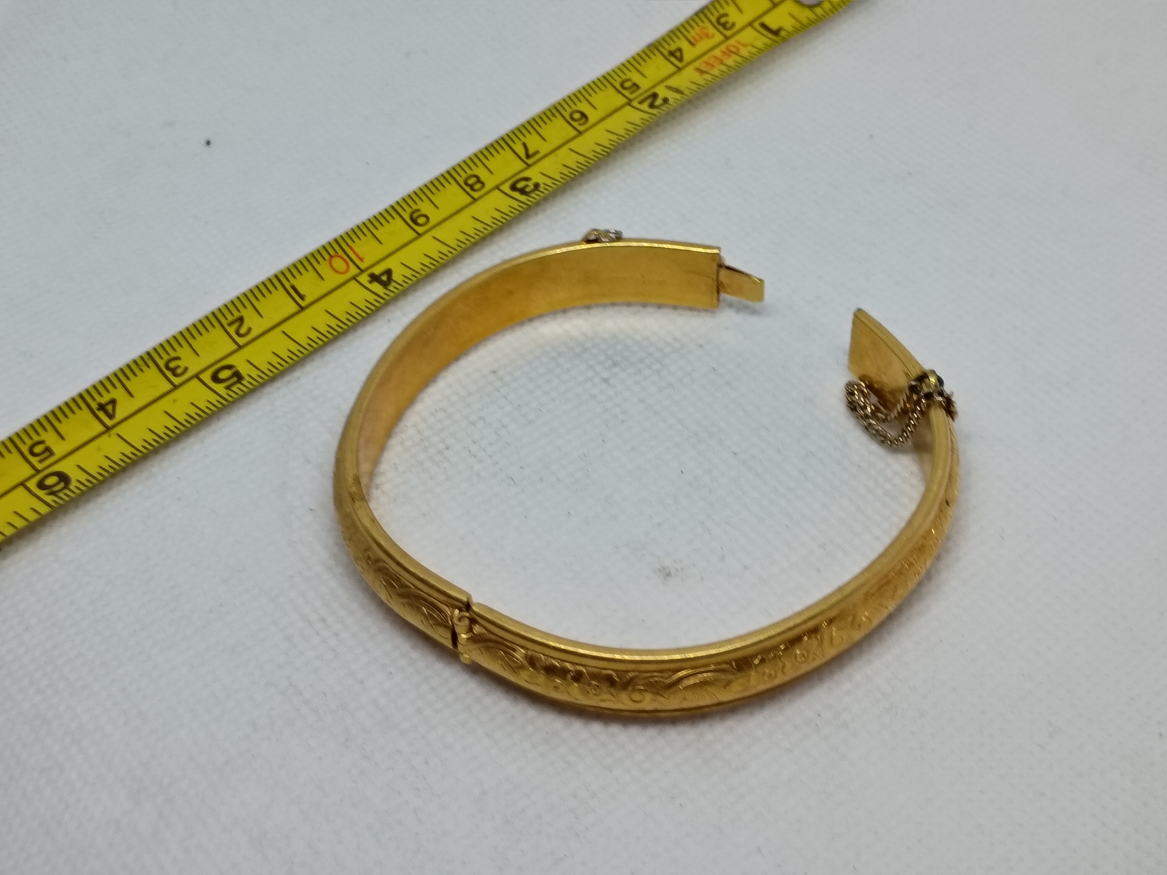 Approx. 2.5" Danecraft 12k gold-filled hinged bangle bracelet features engraving
