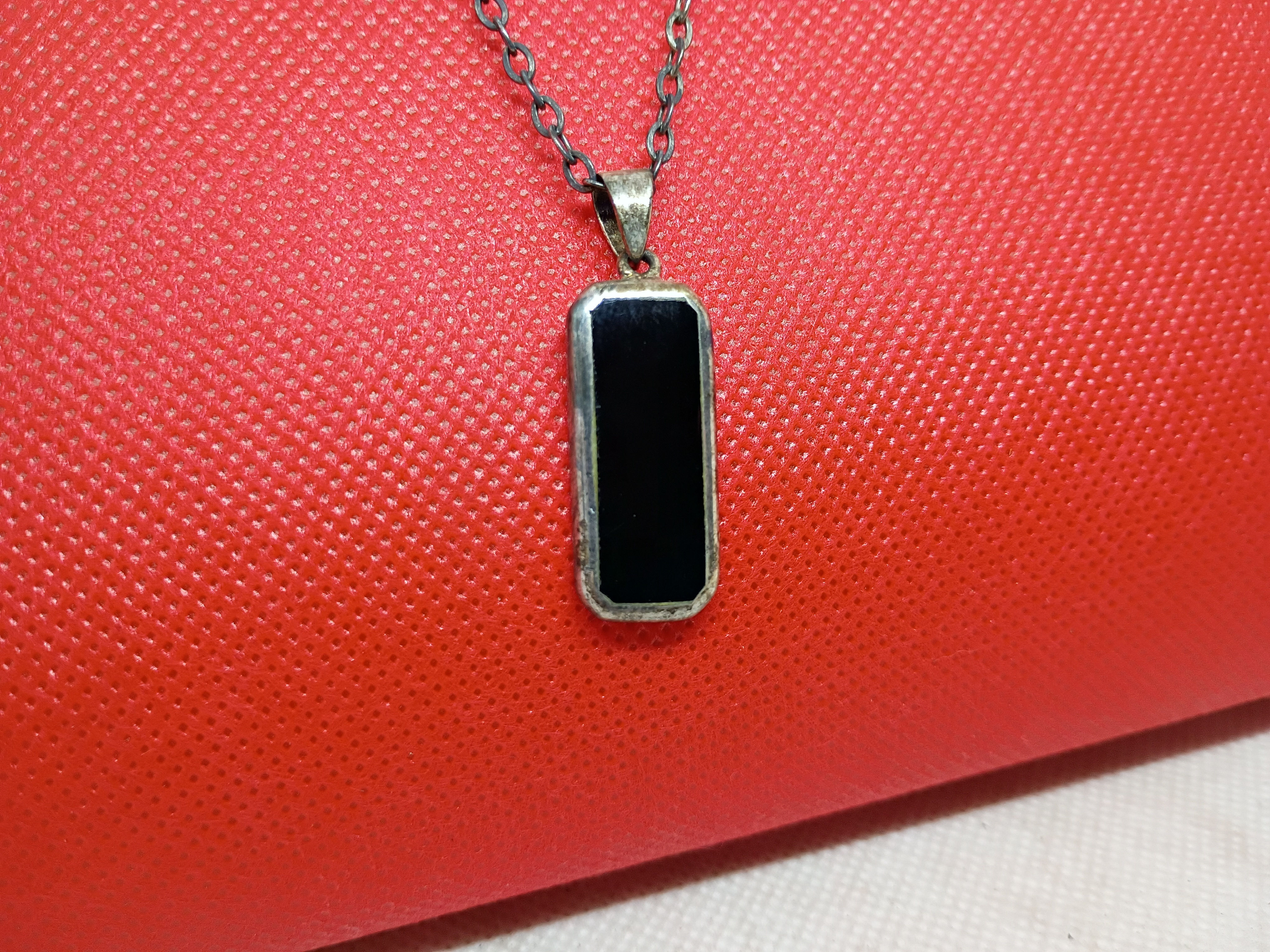Approx. 23"necklace-a rectangular black onyx pendant set in textured metal base