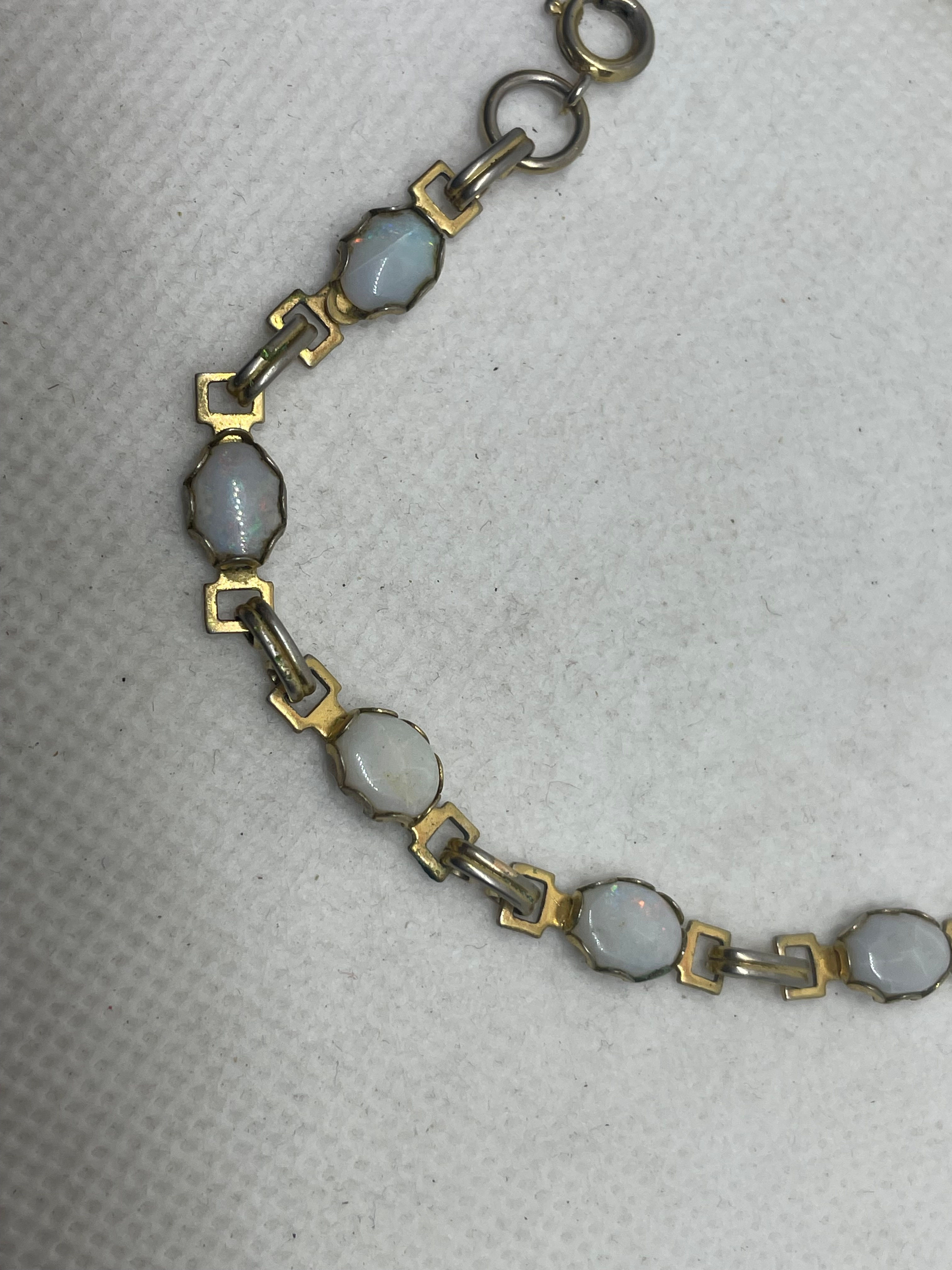 7" Gold tone bracelet with  white gems, undetermined materials