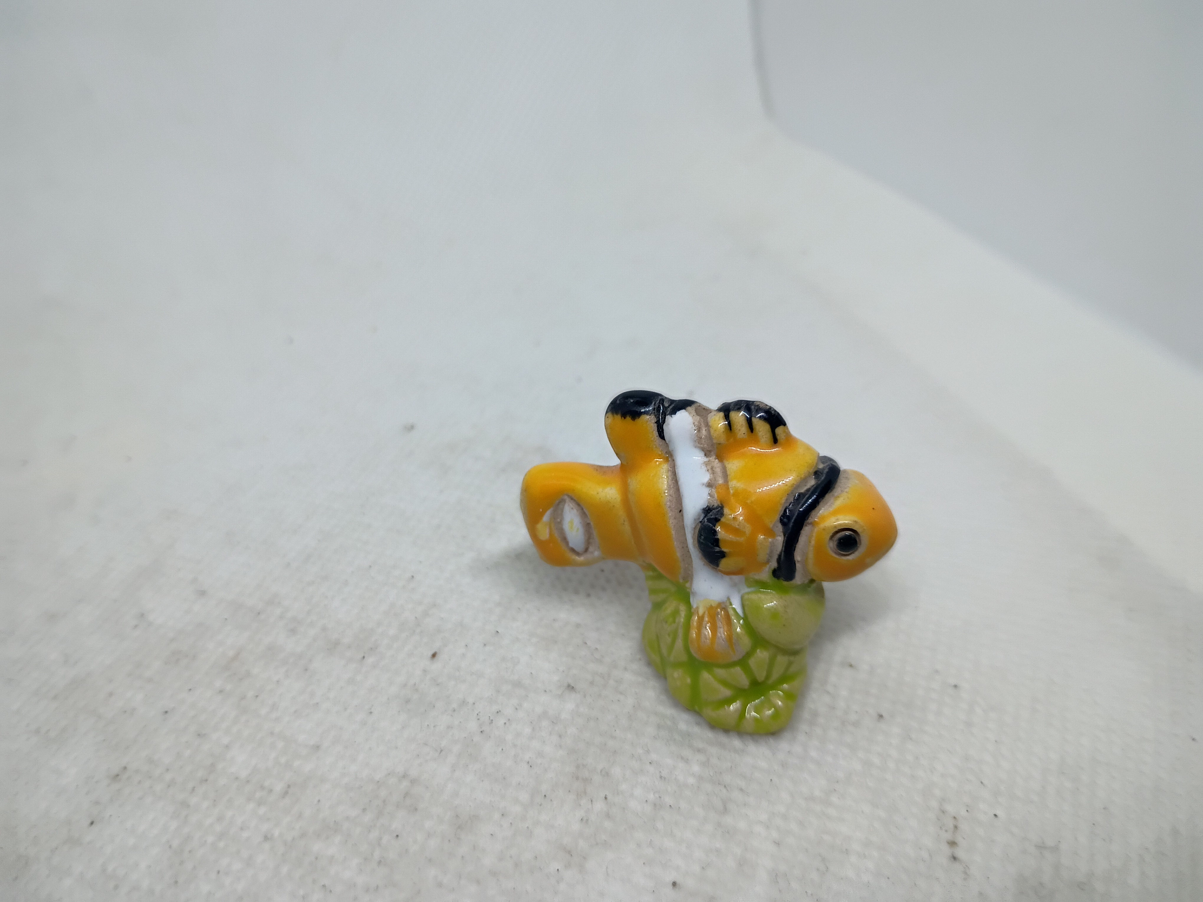 1.5" long - a small, hand-painted ceramic figurine
