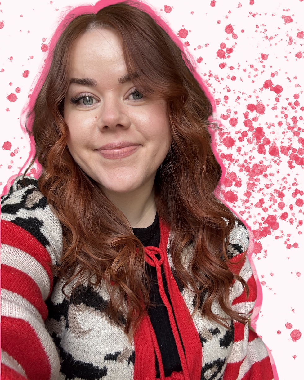 Smiling woman with reddish-brown hair in a patterned sweater