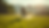 Wide angle view of a grassy field where a dog is running to retrieve a frisbee