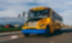 3/4 view of school bus barreling down the highway