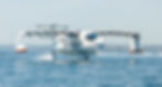 REGENT Seaglider crossing a bay under hazy skies during its testing program.