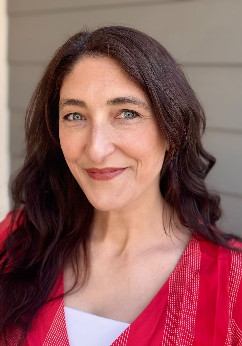 Bio photo of Aylene McCallum wearing a red dress over a white top.