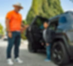 Driver from HopSkipDrive helps student disembark from private vehicle.