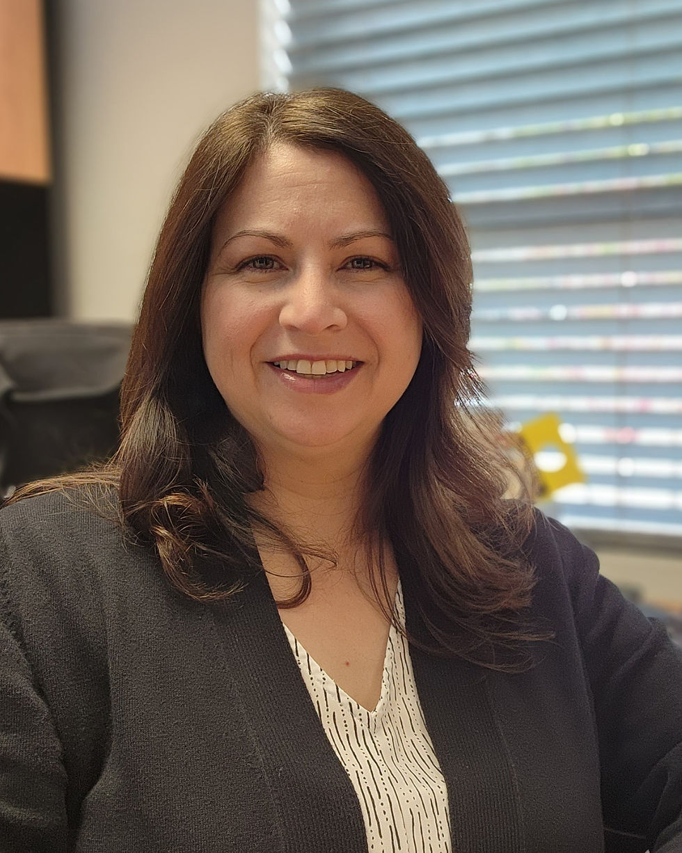 Bio photo of Jennifer Torres seated in her office at LAWC