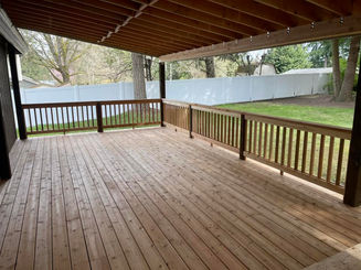 large wooden deck with covered patio