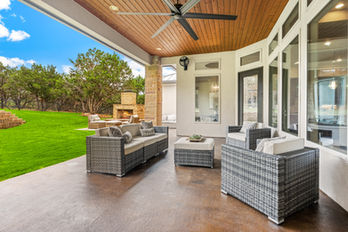 beautiful white and wood covered patio backyard living area