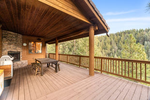 wood deck with railings and covered patio