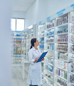 pharmacist-checking-medicines-drugstore_