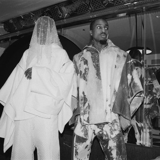 Black and white photo of 2 men standing next to each other
