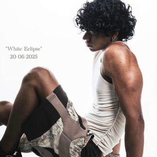 Man in white t-shirt and custom shorts sitting and posing for camera