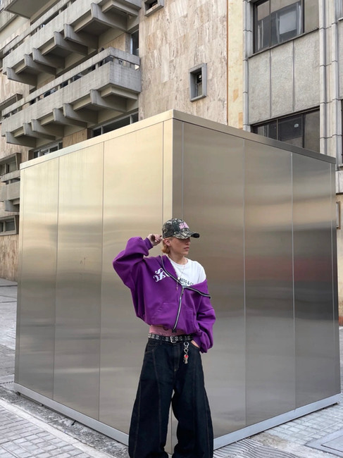 Man wearing purple jacket with black jeans