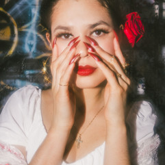Close up portrait of woman with red flower in her hair