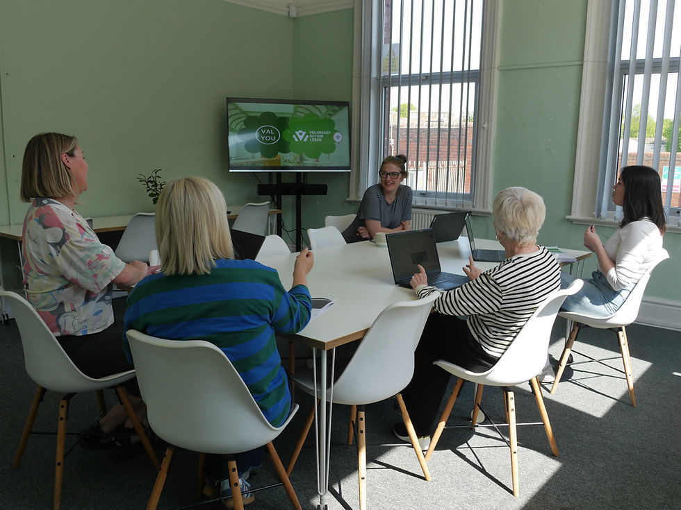 Modern meeting room for hire at Voluntary Action Leeds, featuring presentation screen and collaborat