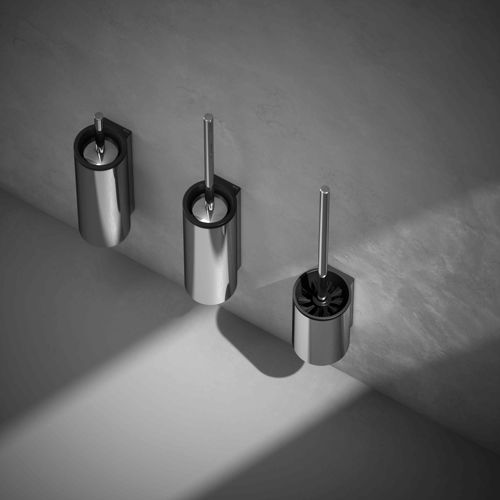 Three metallic toilet brushes mounted on a light gray wall, casting shadows. Minimalist design with a modern and clean aesthetic.