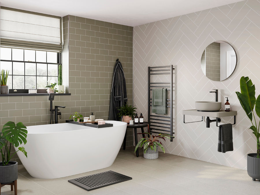 Modern bathroom with white tub, plants, and gray tiles. Round mirror above basin, robe on hook. Calm, minimalist design.