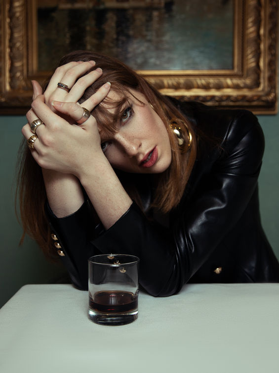 A model poses in a leather jacket for a moody fashion photoshoot in Toronto, captured by Isaiah Haber
