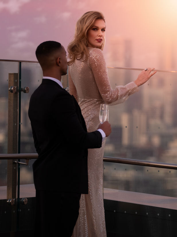 vintage styled fashion photoshoot with a beautiful tall model posed on the roof at Hotel X in Toronto at sunset