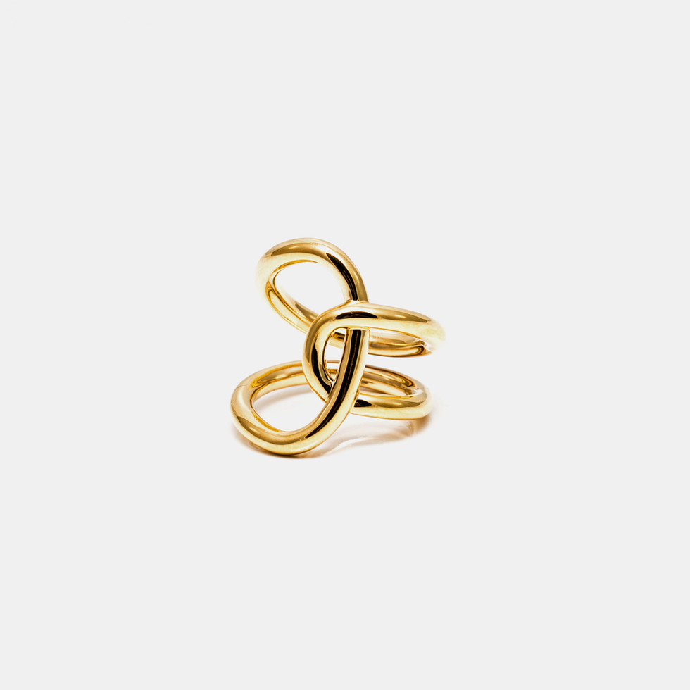 Golden abstract ring on white background. Elegant jewelry design, stylish accessories.