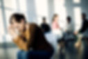 young-sad-woman-sitting-apart-from-attenders-group-therapy-community-center.jpg