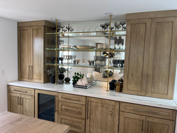 Brass and glass shelving system for bar.
