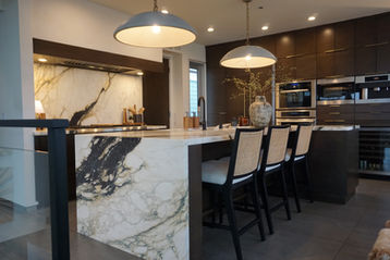 Marble waterfall island. Marble slab backsplash.