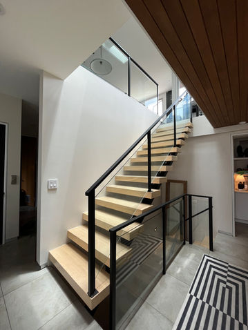 Entry way with glass rail staircase.