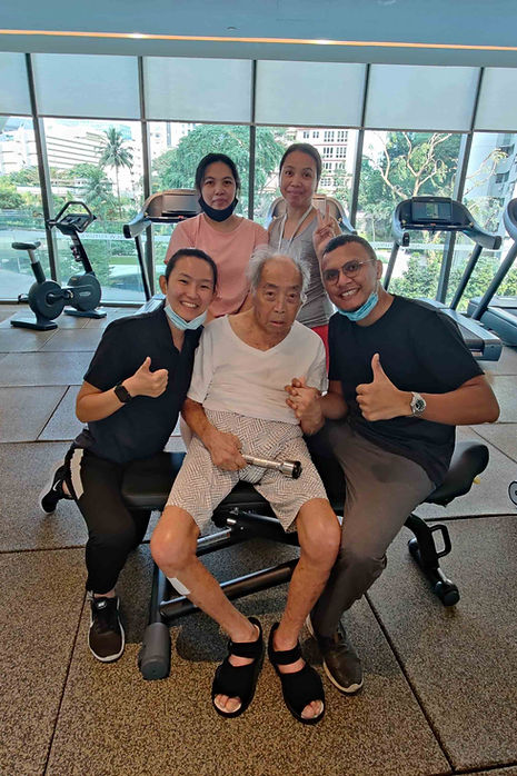 elderly patient doing strength exercises by physiotherapist