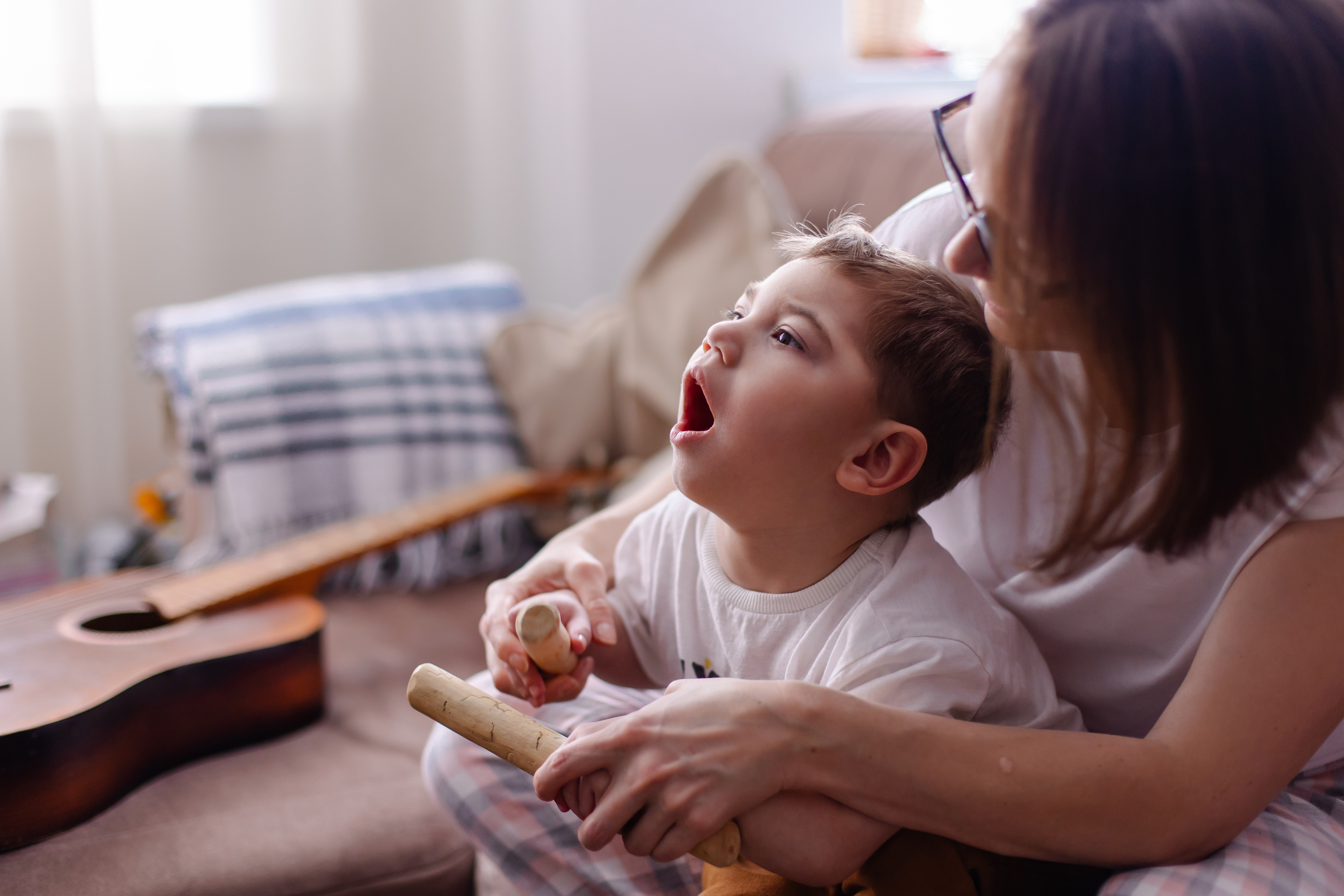Happy family with a child with cerebral palsy The mother and her disabled son lead a norma