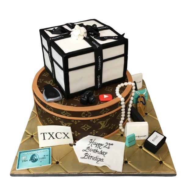 Luxurious designer fashion brand inspired cake with edible Louis Vuitton and Chanel boxes as decorations. Perfect for fashionistas and luxury enthusiasts.