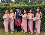 Bagpiper posing with bridesmades at leisha watts wedding Great House Sonning RG4 6UT