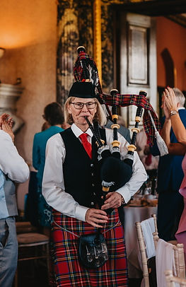 Bagpiper Julia Read Piping the bride and groom to the top table at Ashridge House HP4 1NS.