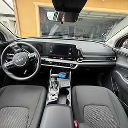 Car interior with dashboard, steering wheel, and front seats