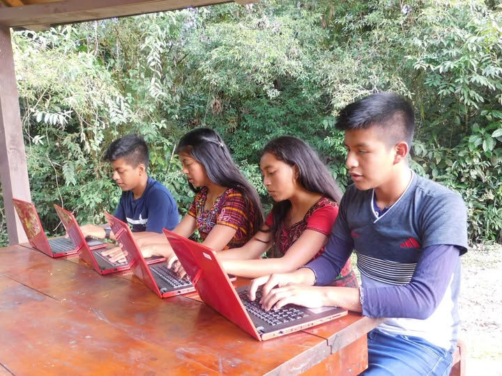 Students working with Starlink internet-connected laptops