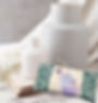 lavender & flax seed eye pillow in teal with white daisies featured in a scene with 2 white vases and white baby's breath