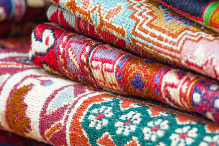Assorted rolled rugs displayed in a showroom