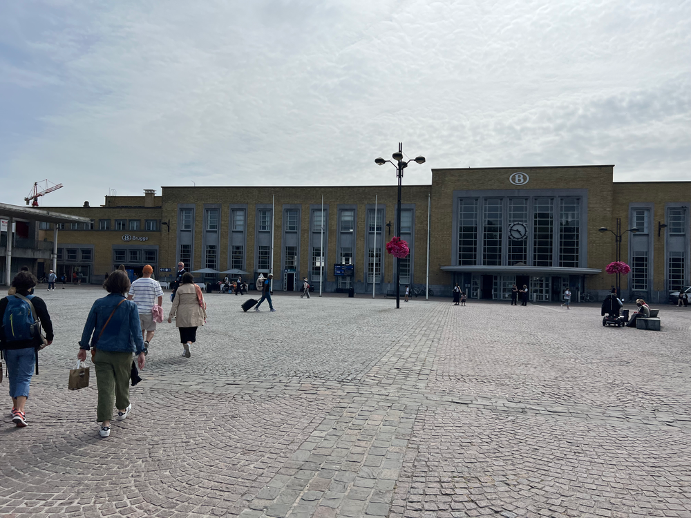 a group of people walking in a plaza