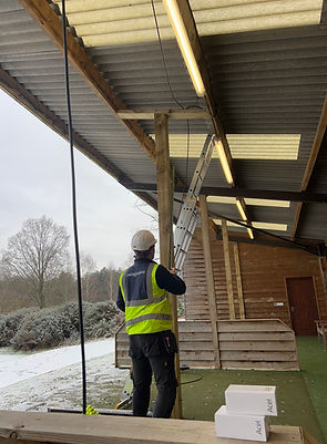 worker measuring post trackman.JPG