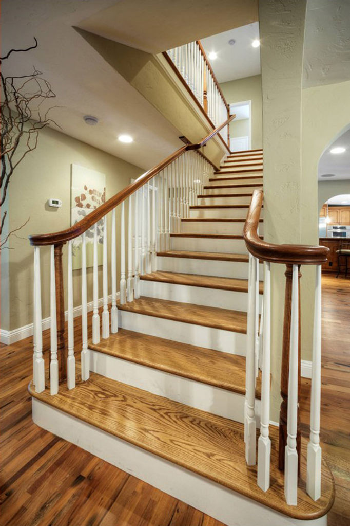 Hardwood staircase with white risers and railings