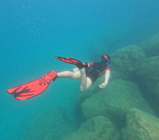 snorkeling in crystal-clear turquoise water near white cliffs in Paxos Greece